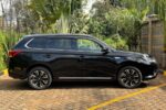 Mitsubishi Outlander PHEV, plug-in hybrid SUV Kenya, import Mitsubishi Outlander PHEV Japan, 2.4L MIVEC hybrid engine, twin electric motor SUV, Super All-Wheel Control S-AWC, electric-only range SUV, fuel-efficient hybrid Kenya, CHAdeMO fast charging, regenerative braking paddles, spacious 5-seater family SUV, panoramic sunroof crossover, leather interior package, advanced safety features, adaptive cruise control, 360-degree camera system, power tailgate SUV, best hybrid SUV Nairobi, second-hand cars Mombasa port, buy Mitsubishi Outlander online Kenya, car import agency Mombasa Road, Japanese auction grade cars, Nairobi car yards, Mombasa Road motor dealers, Ngong Road car showroom, Kiambu Road auto outlets, Thika Road car sales, Nakuru car importers, Eldoret vehicle sales, Kisumu car dealers, Mombasa car imports, Nyeri motor vehicles, Meru car buyers, Malindi vehicle imports, Diani coastal cars, financing for cars Kenya, bank asset finance vehicles, comprehensive car insurance Kenya, spare parts Kirinyaga Road, genuine Mitsubishi parts Nairobi, trusted car dealers Kenya, GN0W chassis Outlander PHEV, GG3W model upgrade Kenya, 13.8 kWh lithium-ion battery, home charging 3-pin plug Kenya, Type 1 to Type 2 adapter cable, public EV charging stations Nairobi, KRA import duty hybrid cars, NTSA motor vehicle registration, asset financing bank loans, comprehensive motor cover Kenya, direct import from Japan, low mileage plug-in hybrid, Black Edition Outlander PHEV, G-Package trim, P-Package luxury trim, S-Edition Bilstein shocks, 190mm ground clearance Kenya, rough road suspension tuning, urban family crossover Kenya, silent electric drive mode, daily commute fuel savings, zero emission city driving, dual-zone climate control, Apple CarPlay Android Auto, smartphone link display audio, heated front seats, power adjustable driver seat, LED headlights and fog lamps, alloy wheels upgrade, roof rails utility, rear spoiler design, multi-information display cluster, electronic parking brake, hill descent control, active stability control ASC, blind spot warning, rear cross traffic alert, forward collision mitigation, lane departure warning, ISOFIX child seat anchors, smart keyless entry, push-to-start ignition, power folding side mirrors, rain-sensing wipers, automatic high beam, premium Rockford Fosgate sound system, USB charging ports rear, 12V auxiliary battery maintenance, hybrid system diagnostic scan, specialized EV mechanics Nairobi, coolant flush service, brake pad replacement, Michelin and Bridgestone tyres, Chloride Exide battery dealers, roadside assistance Kenya, AA rescue coverage, port clearance logistics, container freight station delivery, bond warehouse release, logbook transfer process, TIMS account verification, annual motor inspection, resale value hybrid cars, eco-friendly driving Kenya, road trip ready SUV, upcountry driving comfort, weekend getaway vehicle, spacious boot capacity, fold-flat rear seats, durable roof racks, premium floor mats, door visors, mud flaps, body protection film, ceramic coating detailing, professional car wash Nairobi, engine bay steam cleaning, interior vacuuming, leather seat conditioning, steering wheel wrap, window tinting legal limits, dash camera installation, vehicle tracking security, anti-theft immobilizer, comprehensive extended warranty, trade-in options Nairobi, certified pre-owned inspection, motor mart alternatives, bazaar car sales events, online auto listing platform, top-rated family car Kenya, executive commuter crossover